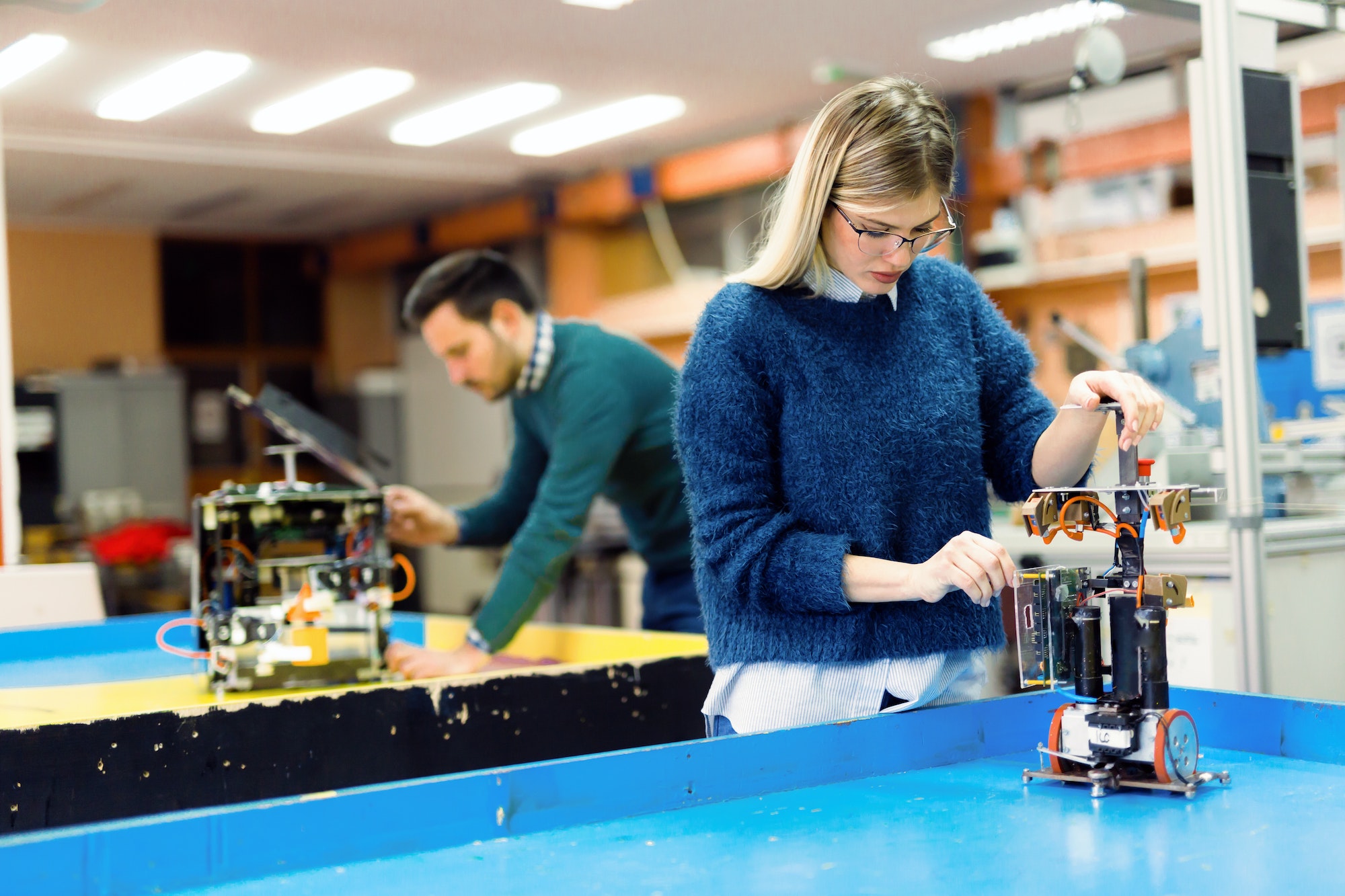 Young woman engineer working on robotics project